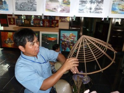 Hou, tour guide, Demonstrates Conical Hat Making