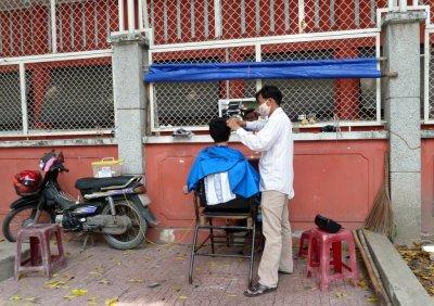 Sidewalk Barber in Saigon