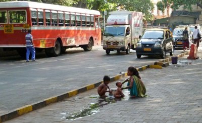 Getting a Bath on the Sidewalks of Mumbai, India