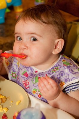 Spoon feeding herself