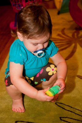 Amelia plays with the plastic Slinky