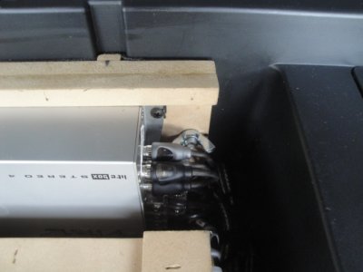 Wing nuts hold the other two amps up against the vertical wall of the storage compartment.
