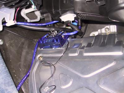 Power lead comes across to fused distribution block below glove box.
