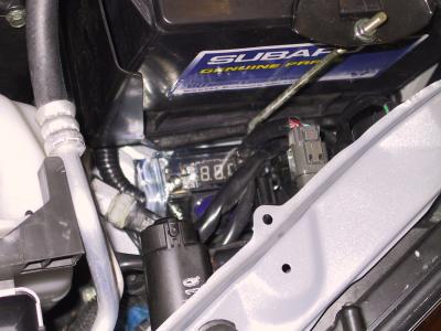 Fuse holder/voltage meter tucked down in front of the battery.