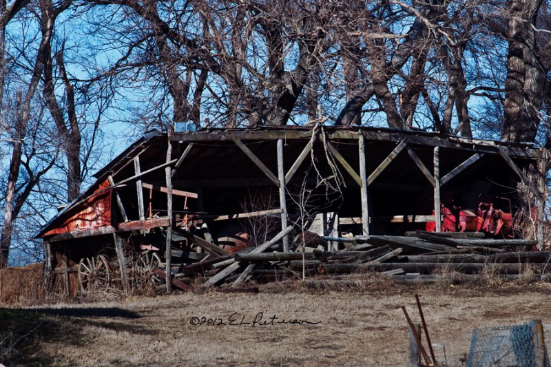 Looking closely you can see an IH corn picker, wagon wheels and some type of a combine paddle. It has been awhile since this shed was used.
An image may be purchased at http://edward-peterson.artistwebsites.com/featured/machine-shed-edward-peterson.html