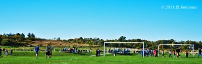 A nice fall day and all the soccer fields are activity.