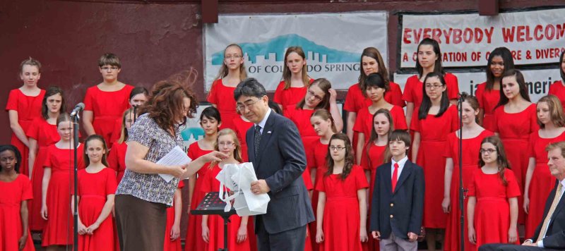 The choir then makes a presentation to the Consul General