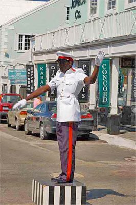 Constable directing traffic at a busy Nassau intersection 