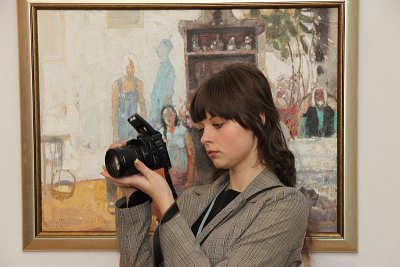 Portrait of photographer with a paint in background