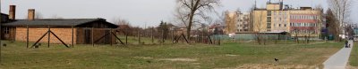  A mother and her children walking in the park at the entrance to the camp