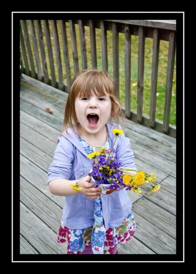 Showing off the flowers she picked