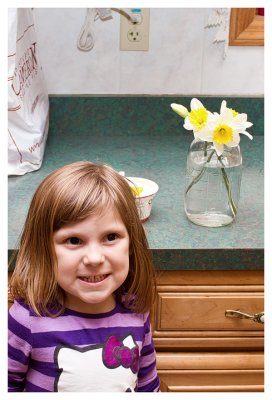 Spring is here!  Norah with the daffodils she picked.