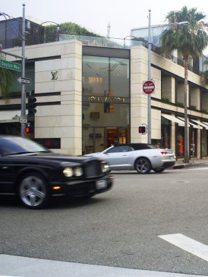 Bentley passing by Louis Vuitton on Rodeo Drive