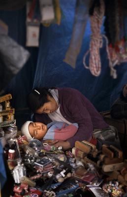 Sleeping woman and child in market, La Paz