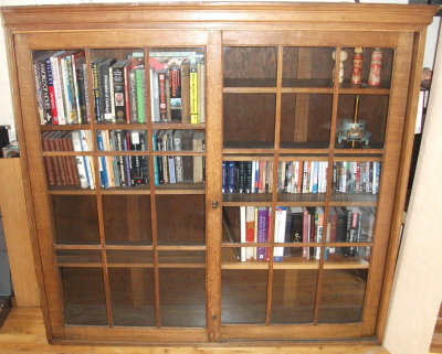 Oak bookcase with sliding doors