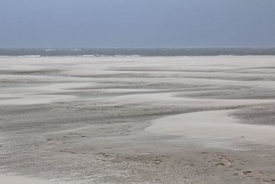 Stuivend zand op het strand