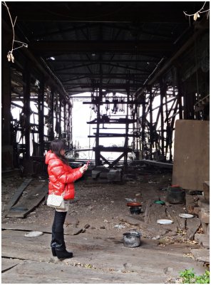 the abandoned shipyard and the photographer in red