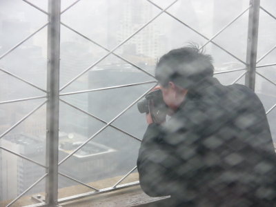 Man Taking Pictures Off Empire State In Rain