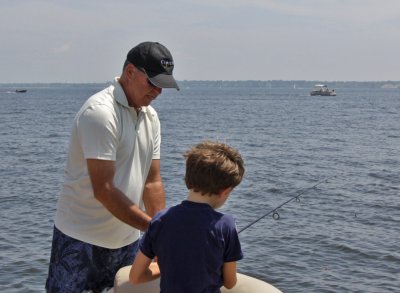 Uncle Ed showing Jack how to fish.