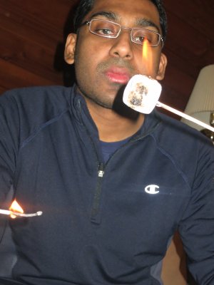 Lowell roasting a marshmallow with a match