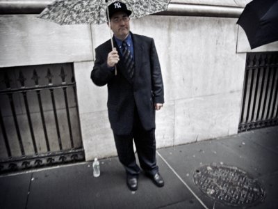 Man With Umbrella And Yankees Cap