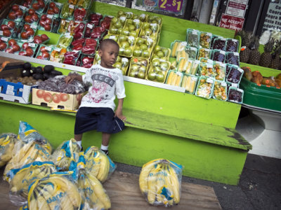Boy At Fruit And Vegetable Stand