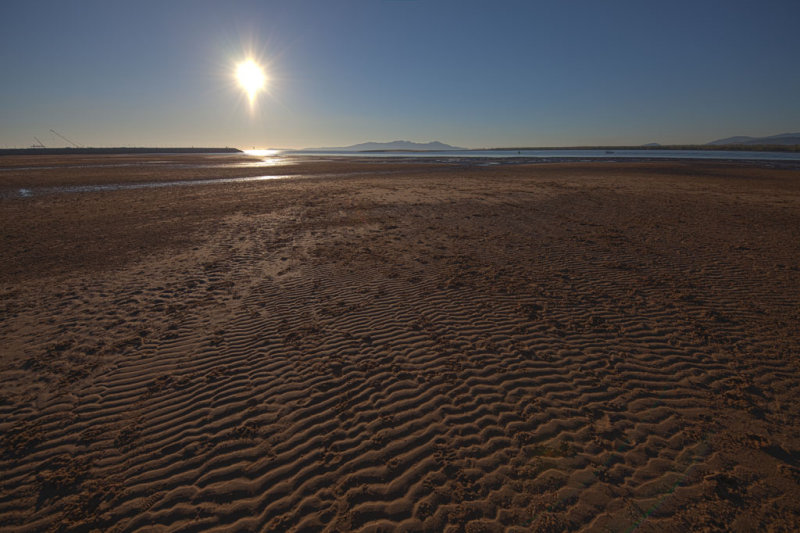 Ripples and just risen sun on flat