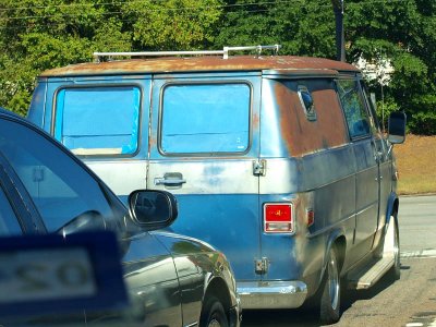 Rusty van caught in traffic.