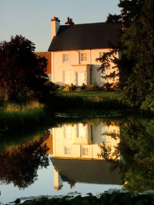 c18th  Century  Mundon  Hall , reflected  at  sunset.