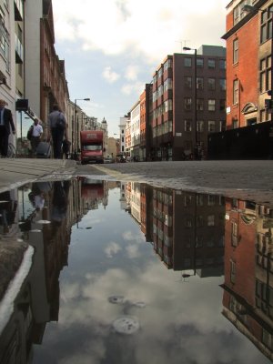 Mortimer  Street  reflected  in  a  puddle.