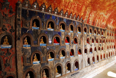 Shrine next to the monastery; niches filled with small statues of Buddha