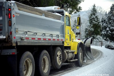 The Snow Plow Truck Sanding the Slick Road