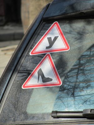 maybe it means Caution: Ukrainian female driver?