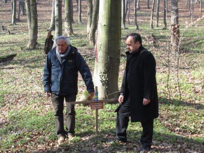 the leaders of this trip pause at a memorial to Italian prisoners of war killed in the same actions
