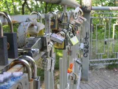 love locks on a pedestrian bridge high over a roadway in Misky Sad park
