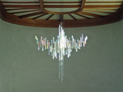 The cross above the altar is made of clear glass, so it reflects all the multicolored light from the stained glass windows.