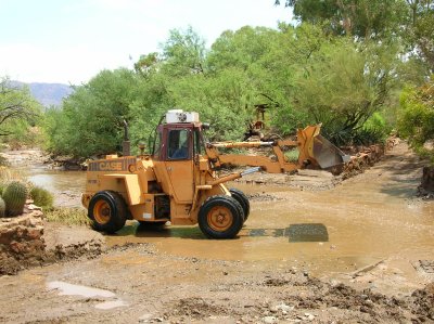 11:58 am. Cleaning the Mud From Silver King Crossing