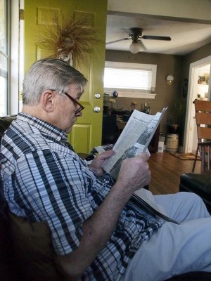 Ron reads the newspaper.