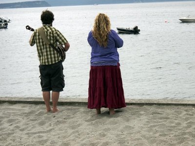 The minsiter and her husband gaze at the water.