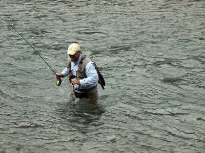 A fisherman wades the creek and finds it too deep for his breeches!