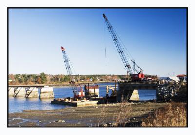 The footbridge is being reconstructed across the river.