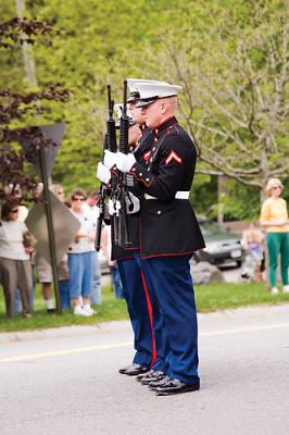 An honor guard gives a 21 gun salute.