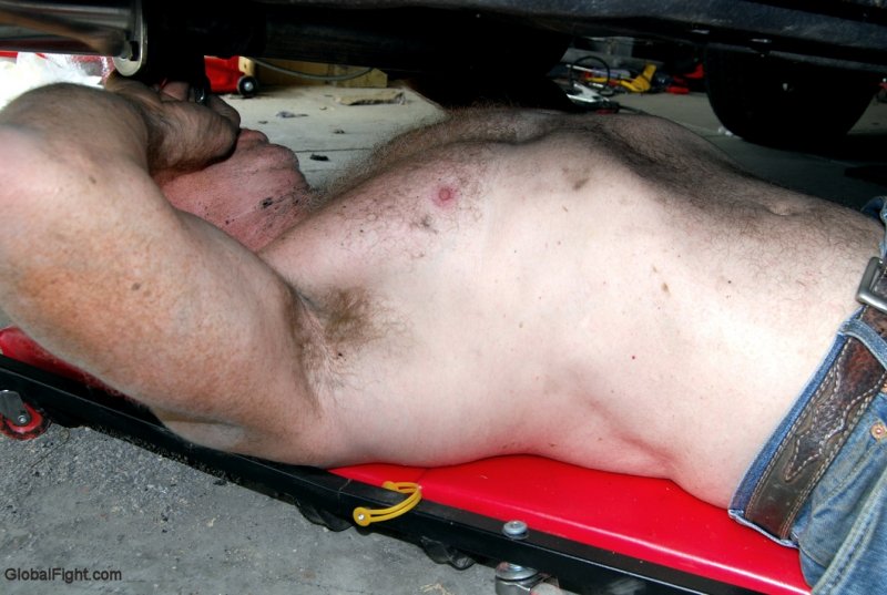 man working shirtless under car.jpg