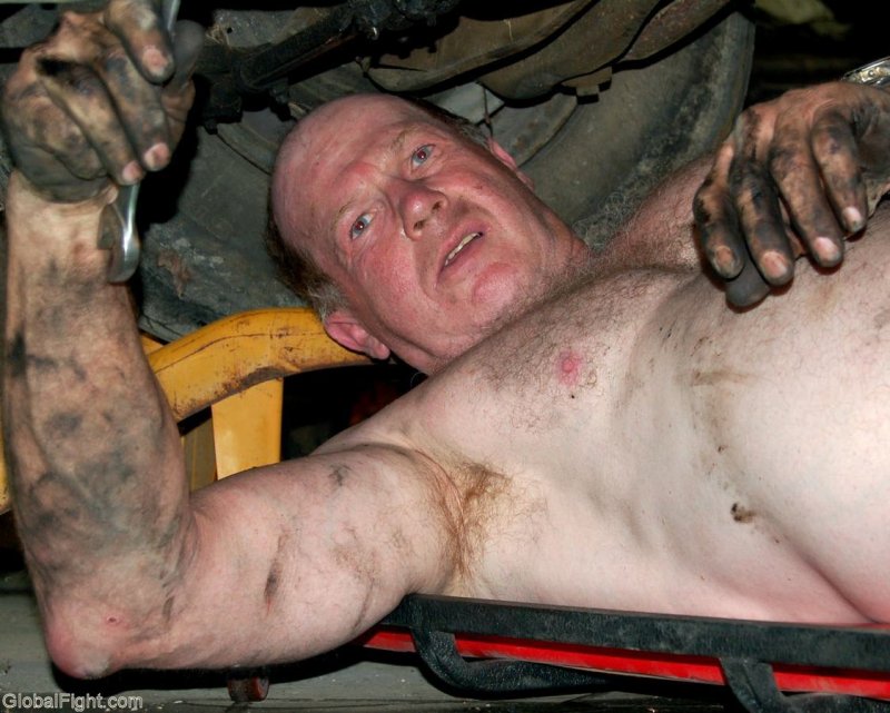 greasy dirty mechanic man working changing oil.jpg