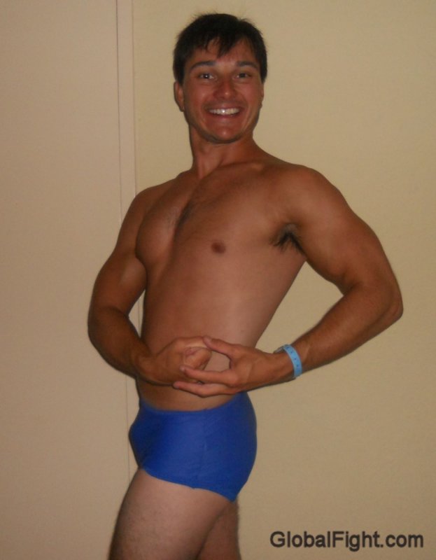 fit trim bodybuilder slim gay guy flexing muscles.jpg