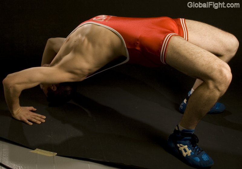 hunky wrestler collegiate man stretching out pre event matches.jpg