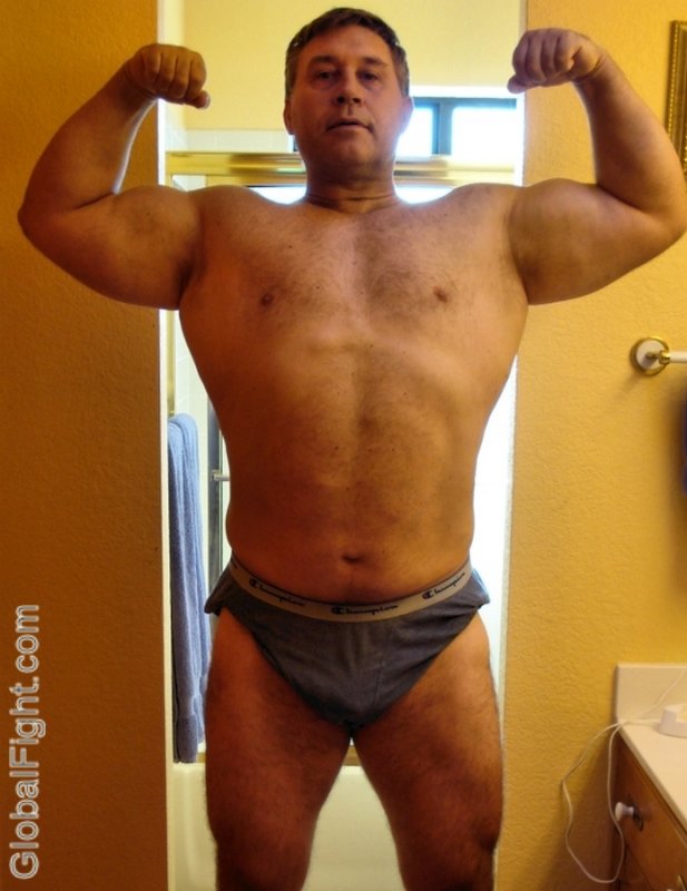 bodybuilder daddy flexing bathroom mirror self photos.jpg