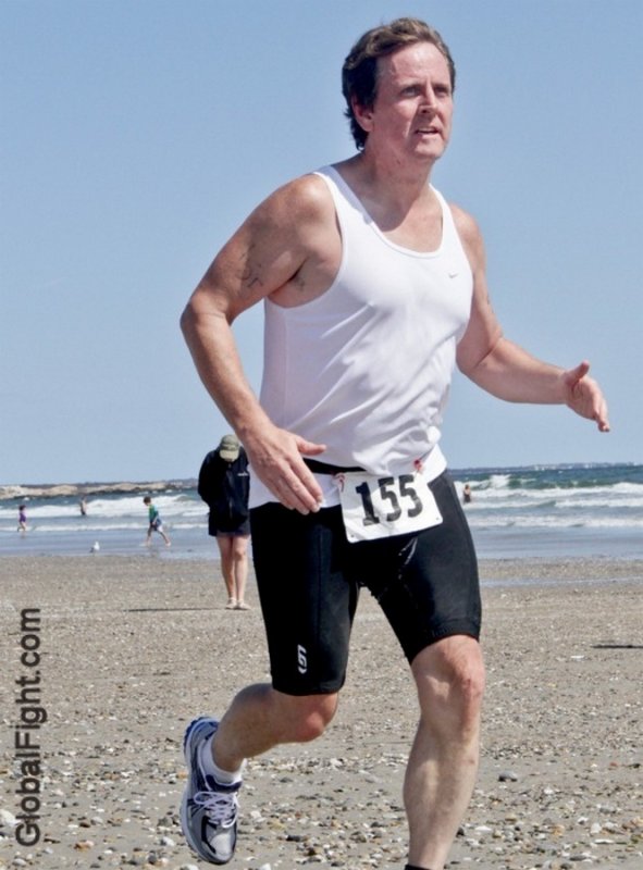 daddy jogging in tanktop on beach.jpg