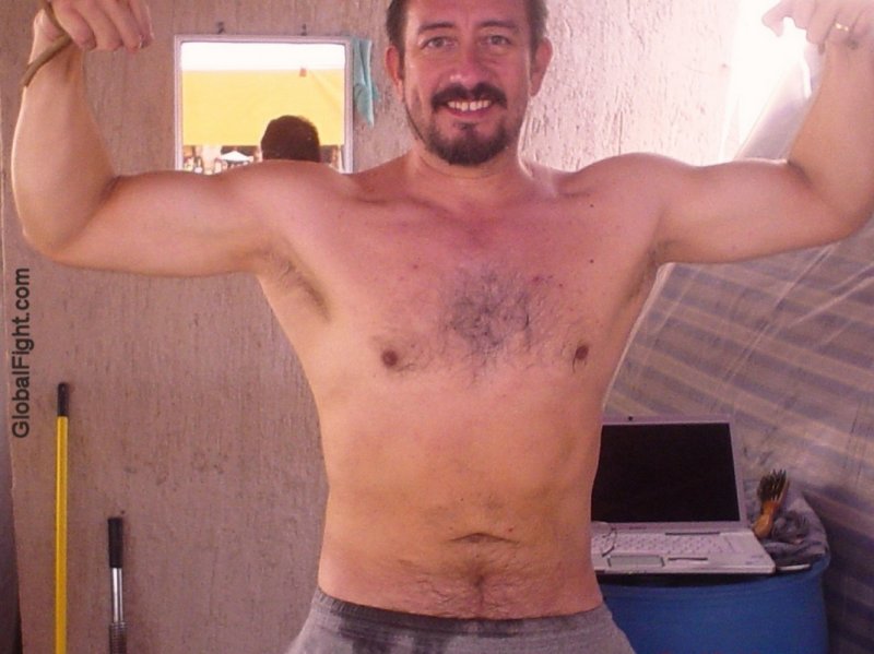 muscled hairy daddy flexing arms.jpg