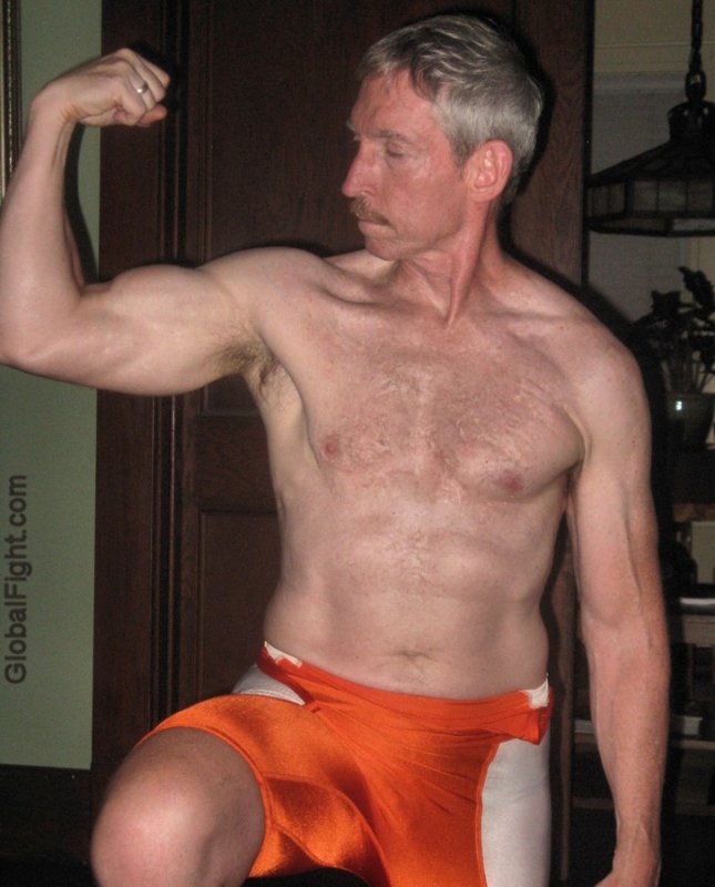 wrestler wearing spandex shorts flexing arms.jpg
